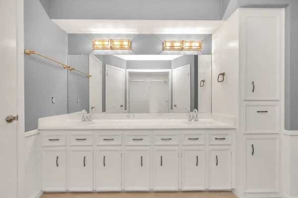a bathroom with a sink vanity and mirror