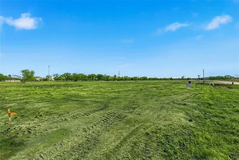 a view of a big yard with a house in the background