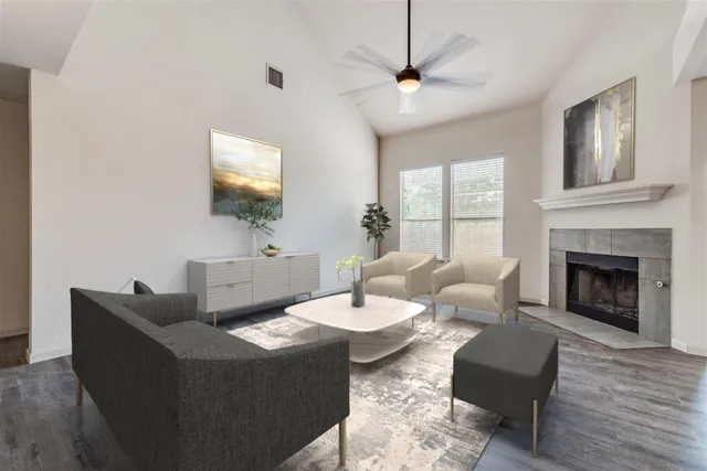 a living room with furniture a fireplace and a flat screen tv