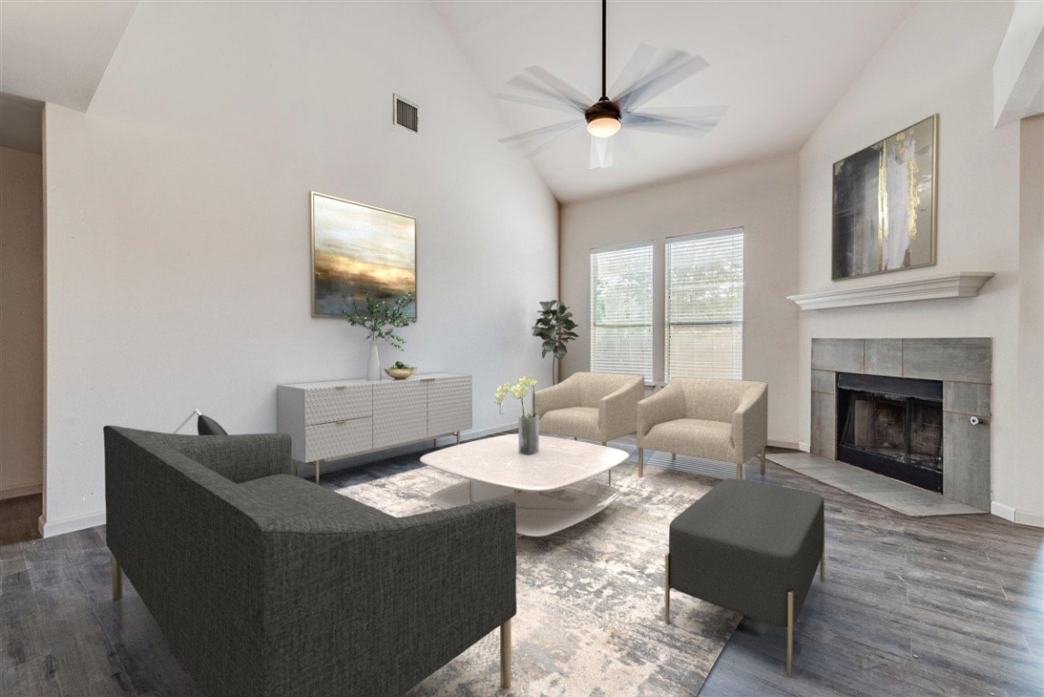 a living room with furniture a fireplace and a flat screen tv