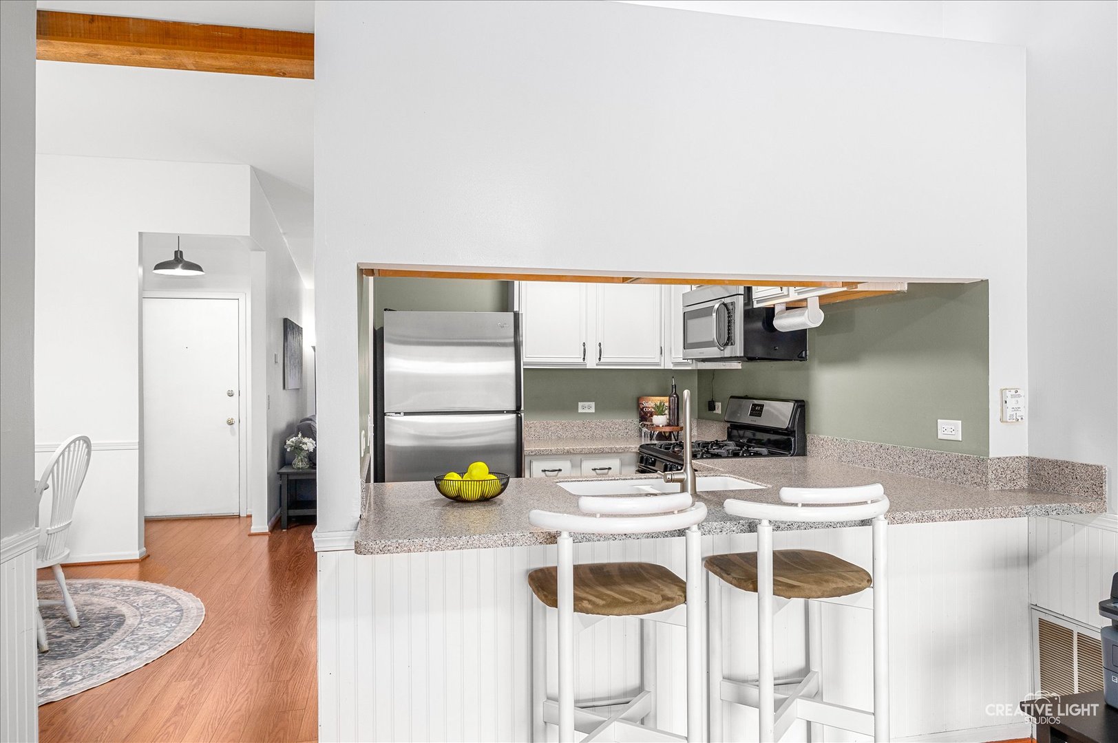 40 Harbor Court, Unit 304 Naperville, IL 60565 - Photo 7 of 18 a kitchen with a sink dining table and chairs