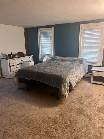 a bedroom with bed and window