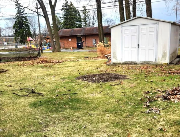 a view of brick house with a yard