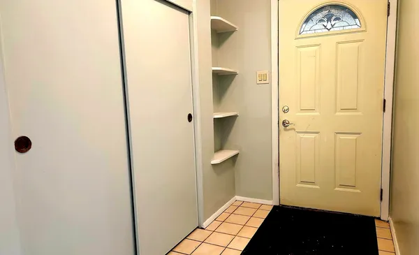 a kitchen with granite countertop a refrigerator a sink and cabinets