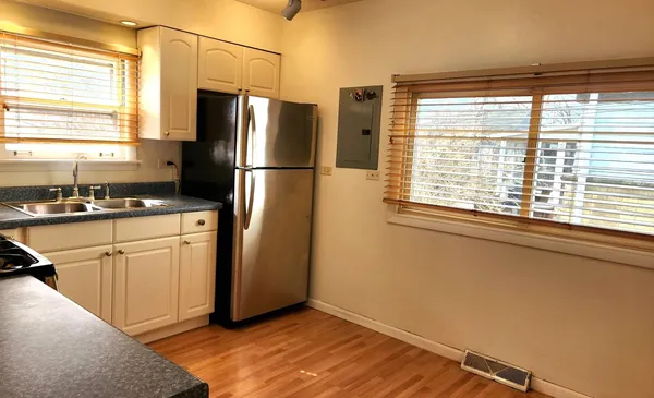 a kitchen with granite countertop white cabinets white stainless steel appliances with a sink and dishwasher