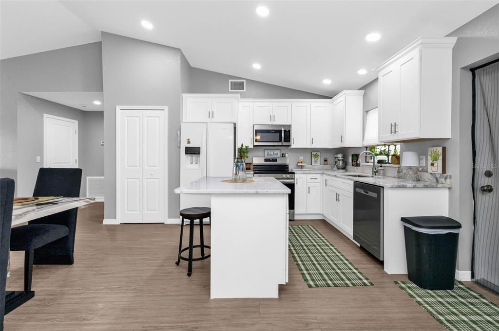 11615 Southwest Orange Avenue Arcadia, FL 34269 - Photo 11 of 27 a kitchen with a sink a counter top space stainless steel appliances and cabinets