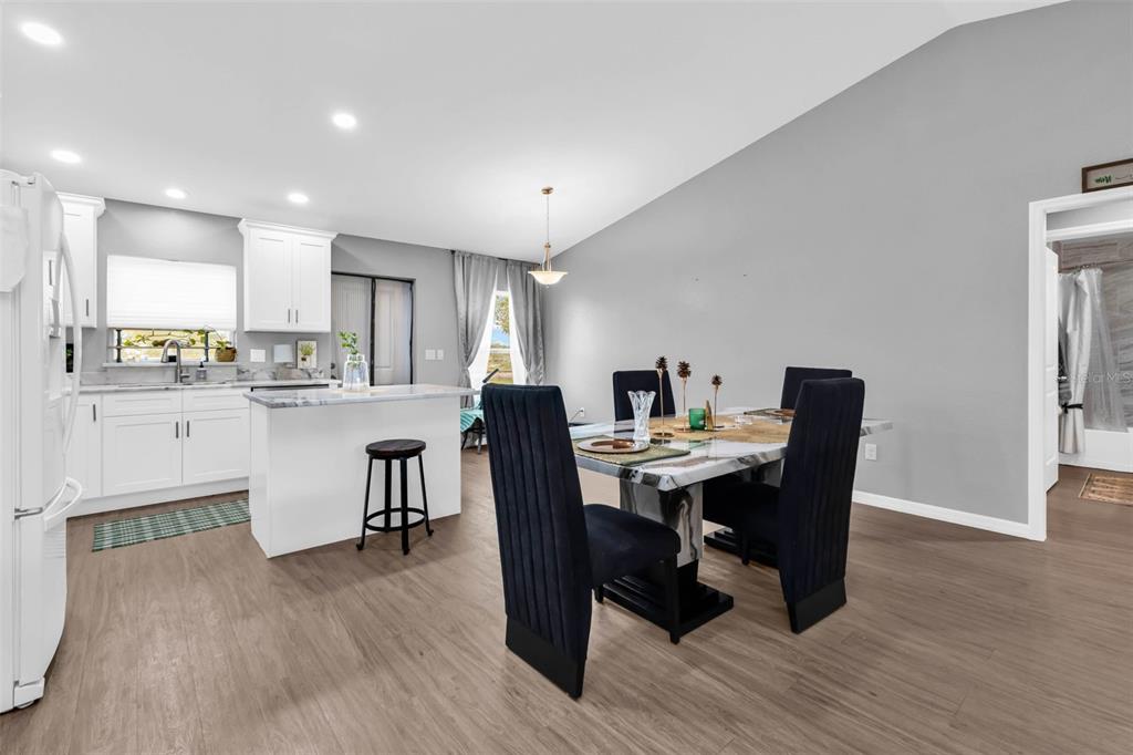 11615 Southwest Orange Avenue Arcadia, FL 34269 - Photo 12 of 27 a view of a dining room with furniture and wooden floor