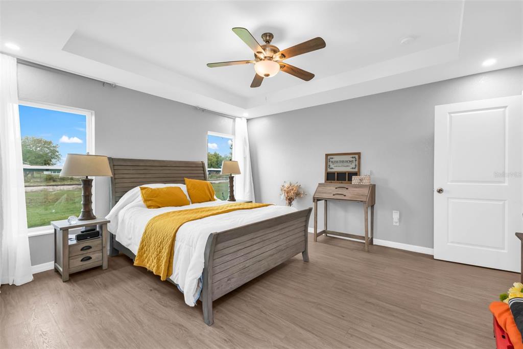 11615 Southwest Orange Avenue Arcadia, FL 34269 - Photo 15 of 27 a bedroom with a bed and a ceiling fan