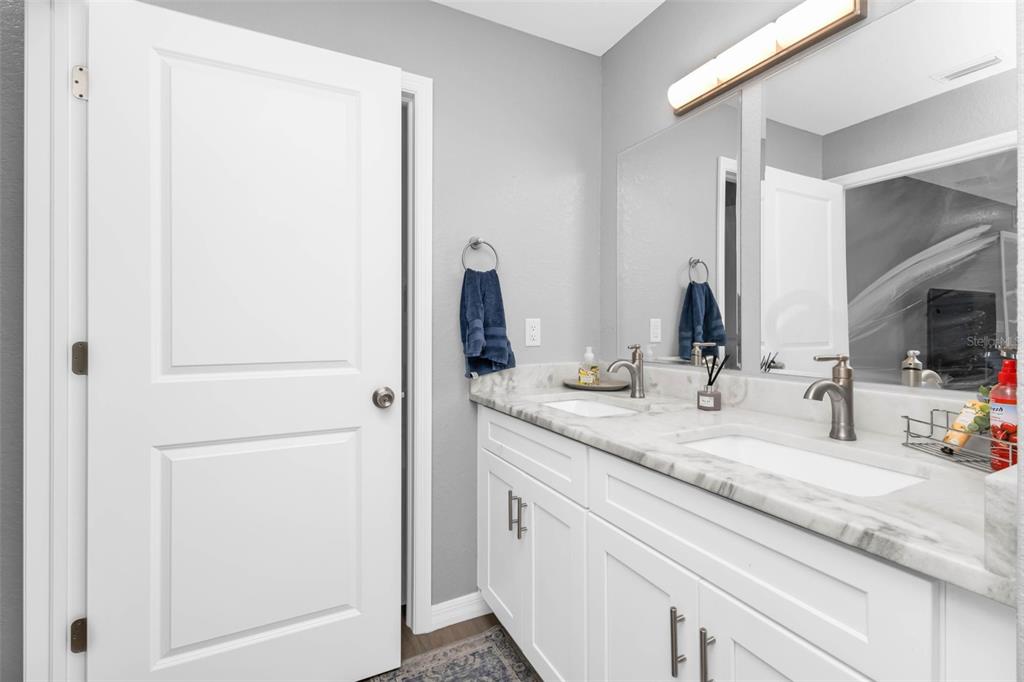 11615 Southwest Orange Avenue Arcadia, FL 34269 - Photo 18 of 27 a bathroom with a double vanity sink and a mirror
