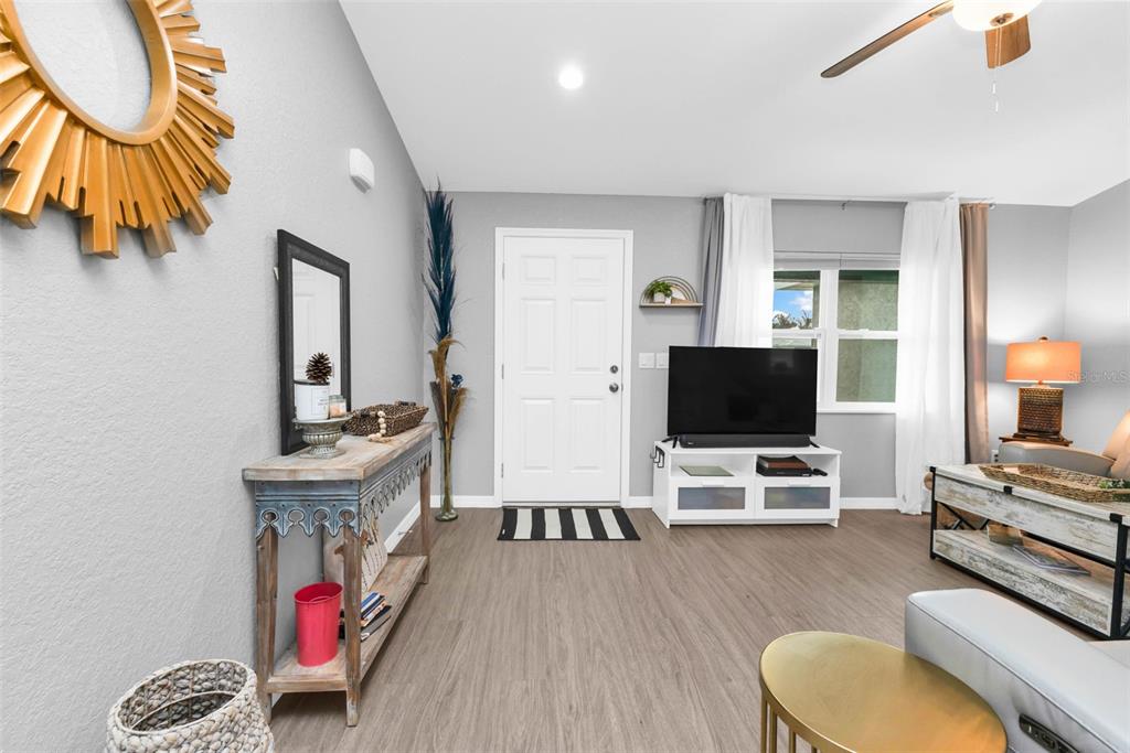 11615 Southwest Orange Avenue Arcadia, FL 34269 - Photo 2 of 27 a living room with furniture and a flat screen tv