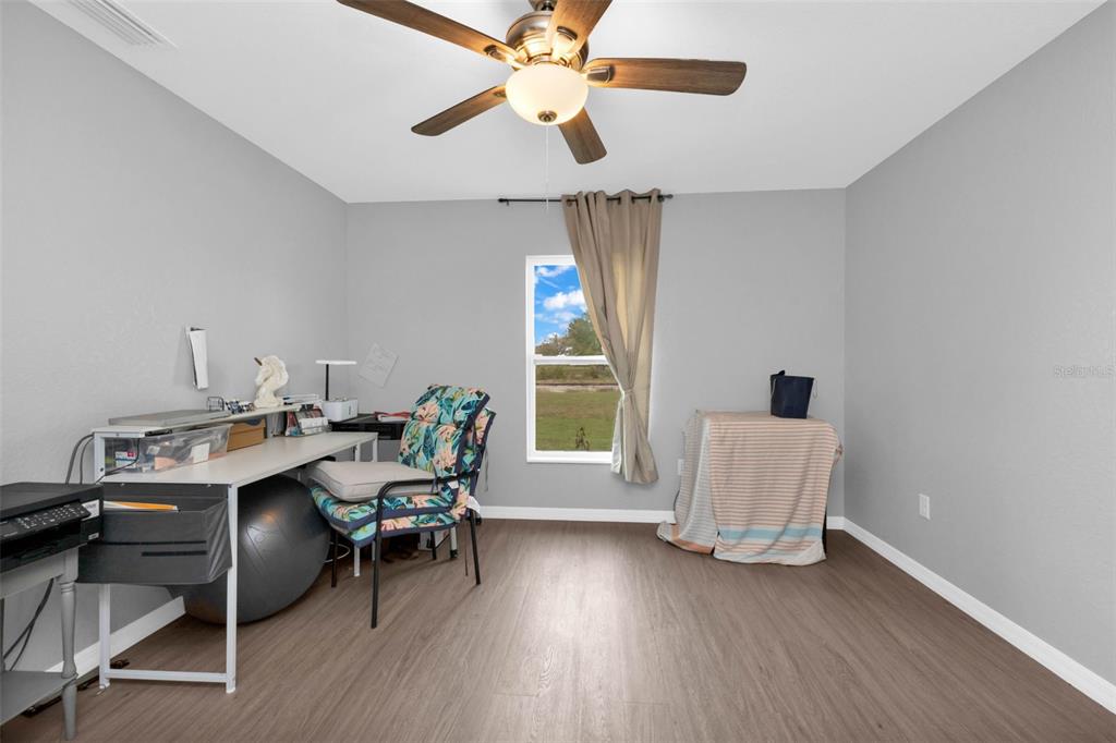 11615 Southwest Orange Avenue Arcadia, FL 34269 - Photo 21 of 27 a workspace with wooden floor and a window