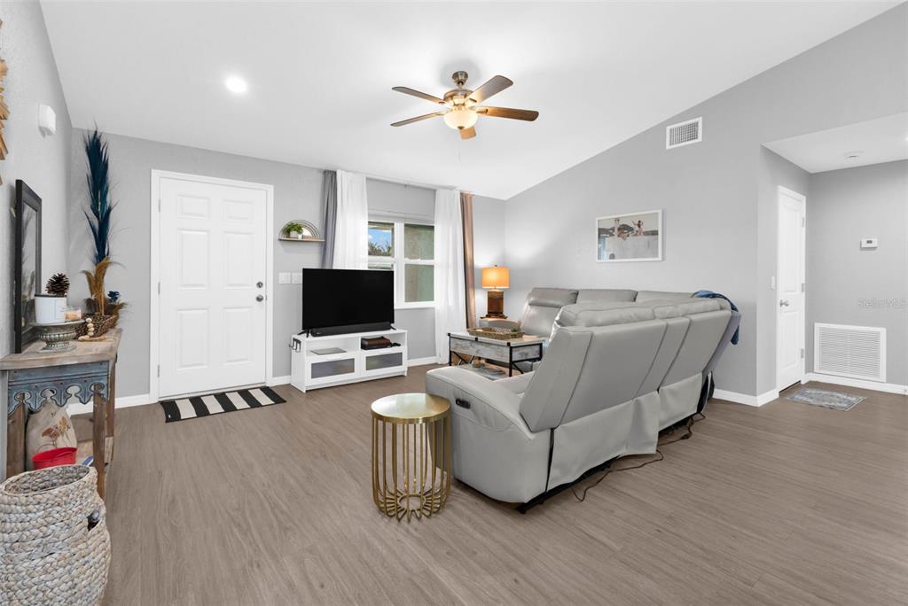 11615 Southwest Orange Avenue Arcadia, FL 34269 - Photo 3 of 27 a living room with furniture and a flat screen tv