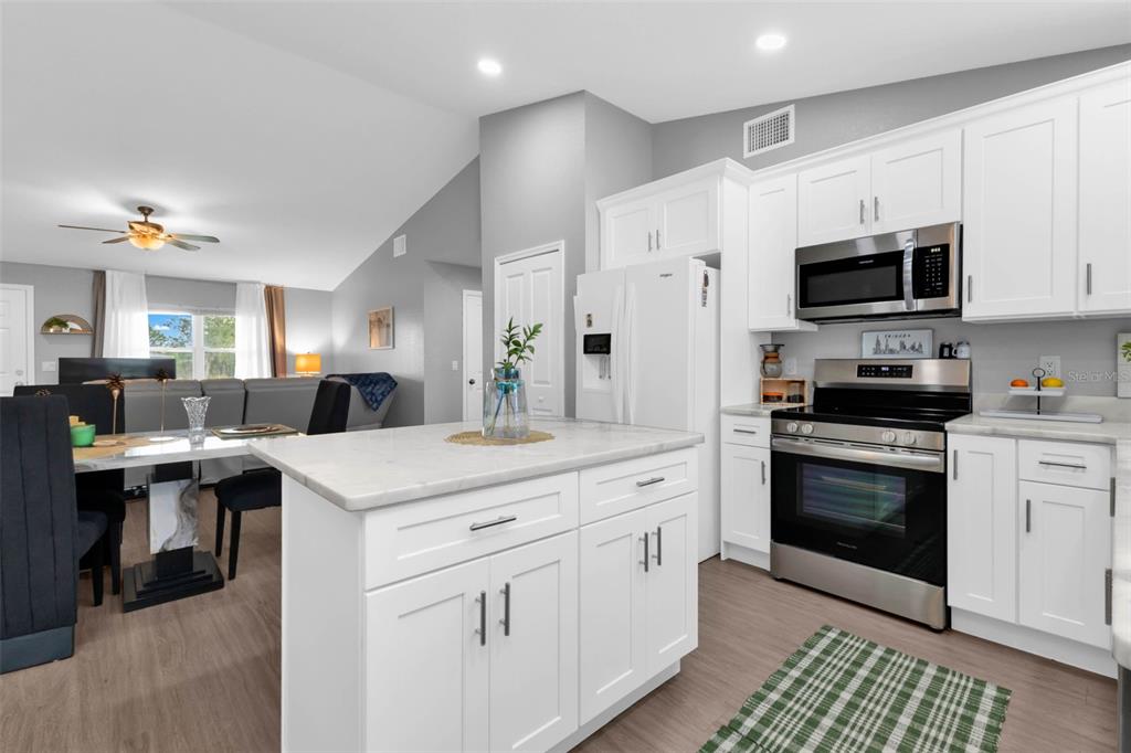 11615 Southwest Orange Avenue Arcadia, FL 34269 - Photo 7 of 27 a kitchen with cabinets appliances a sink and a counter top space