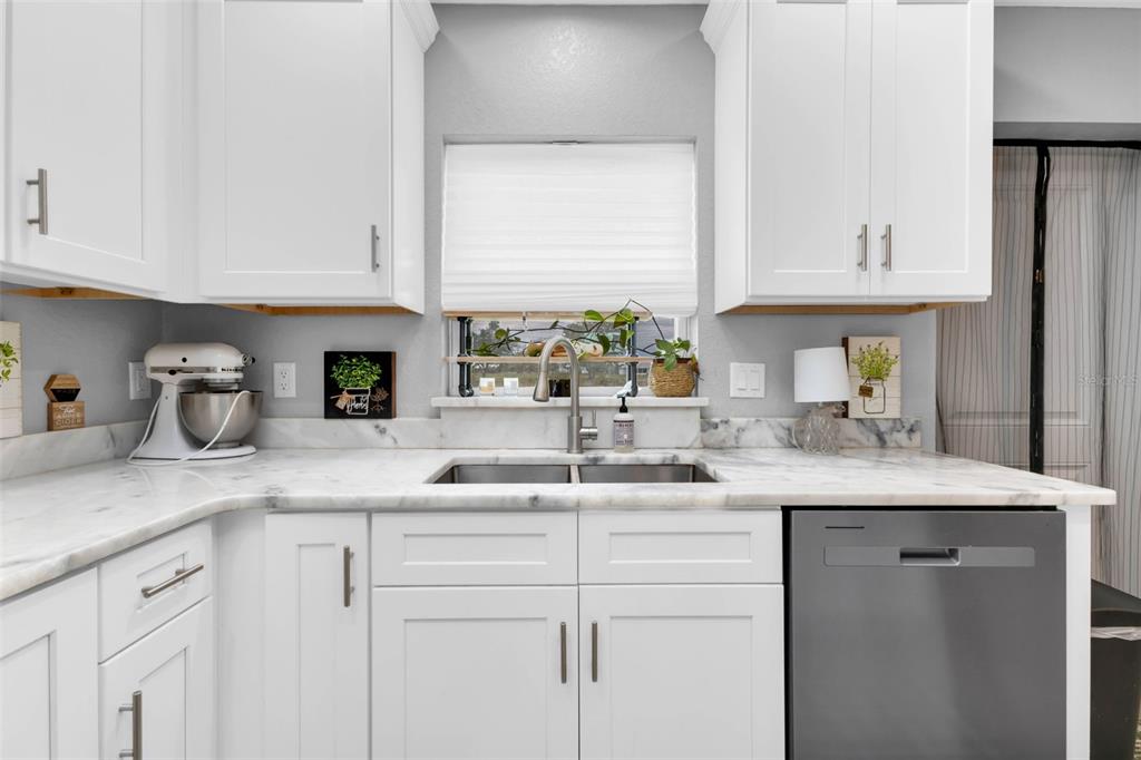 11615 Southwest Orange Avenue Arcadia, FL 34269 - Photo 8 of 27 a kitchen with stainless steel appliances granite countertop a sink and a white cabinets