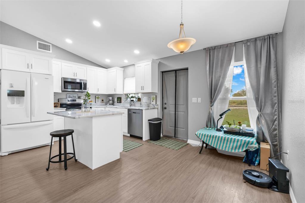 11615 Southwest Orange Avenue Arcadia, FL 34269 - Photo 10 of 27 a kitchen with sink refrigerator and outdoor view