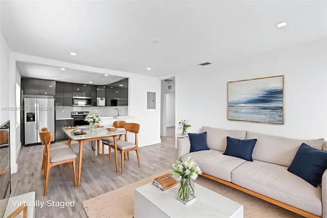 a living room with furniture kitchen view and a table