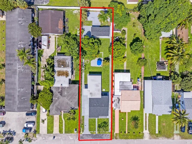 an aerial view of multiple houses with a yard