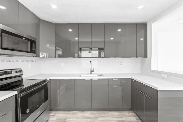 a kitchen with a sink and cabinets