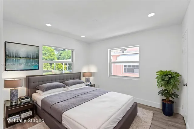 a bedroom with a bed and a large window