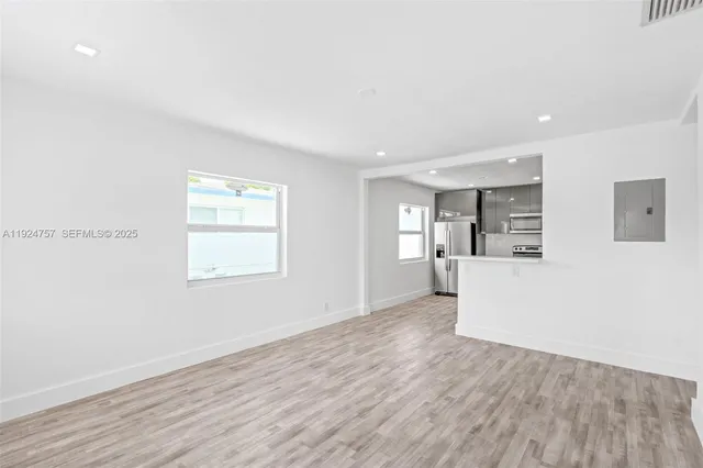 a view of a kitchen with wooden floor and a kitchen space