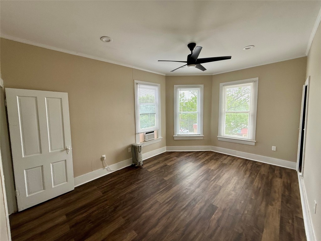 1403 14th Street, Unit 4 Huntsville, TX 77340 - Photo 5 of 9 an empty room with wooden floor ceiling fan and windows