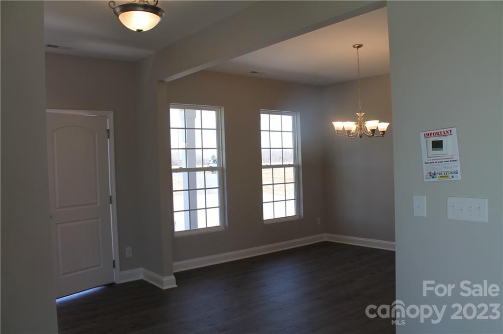 3220 Austin Chaney Road Monroe, NC 28110 - Photo 10 of 18 a view of an empty room with wooden floor and a window
