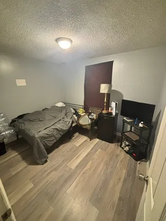 a bedroom with a bed and lamp