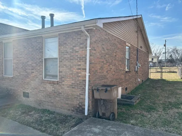 a big room with table and chairs under an umbrella