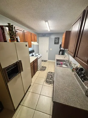 a kitchen with a refrigerator sink and stove