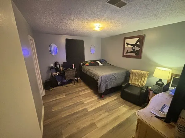 a bedroom with bed and a window