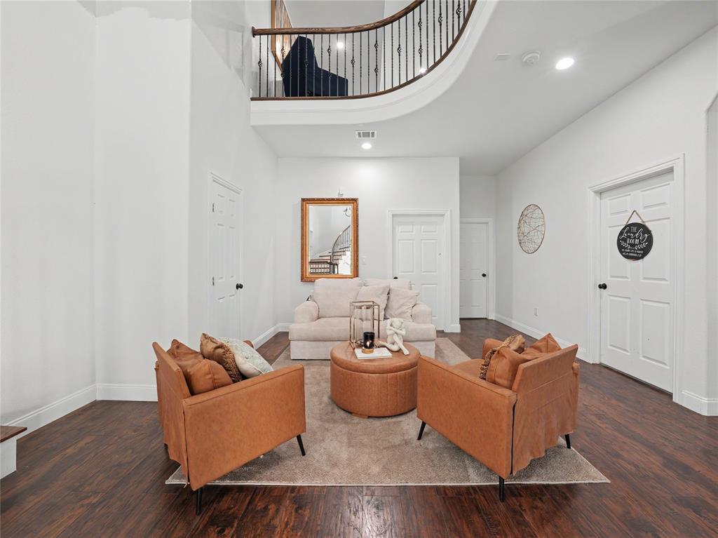 6701 Nauert Road Forest Hill, TX 76140 - Photo 15 of 40 Double-height entry foyer featuring a curved staircase with wrought iron balusters and wood handrail