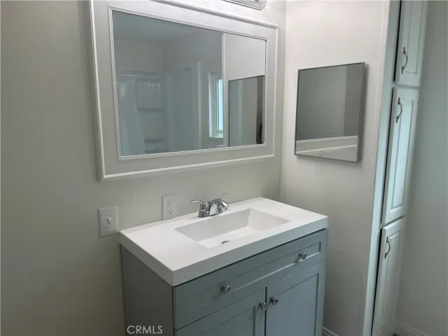 a bathroom with 2 sink and a mirror