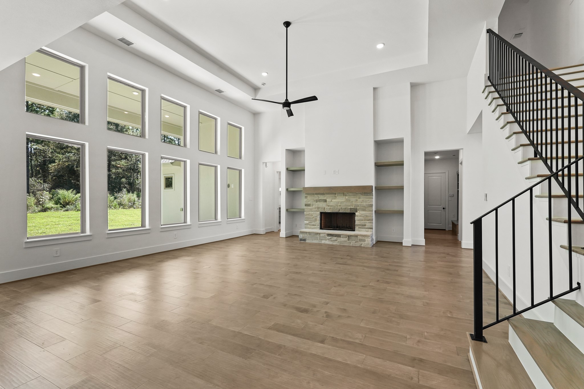 24919 Balmorhea Way Montgomery, TX 77316 - Photo 17 of 36 a view of empty room with wooden floor and fireplace