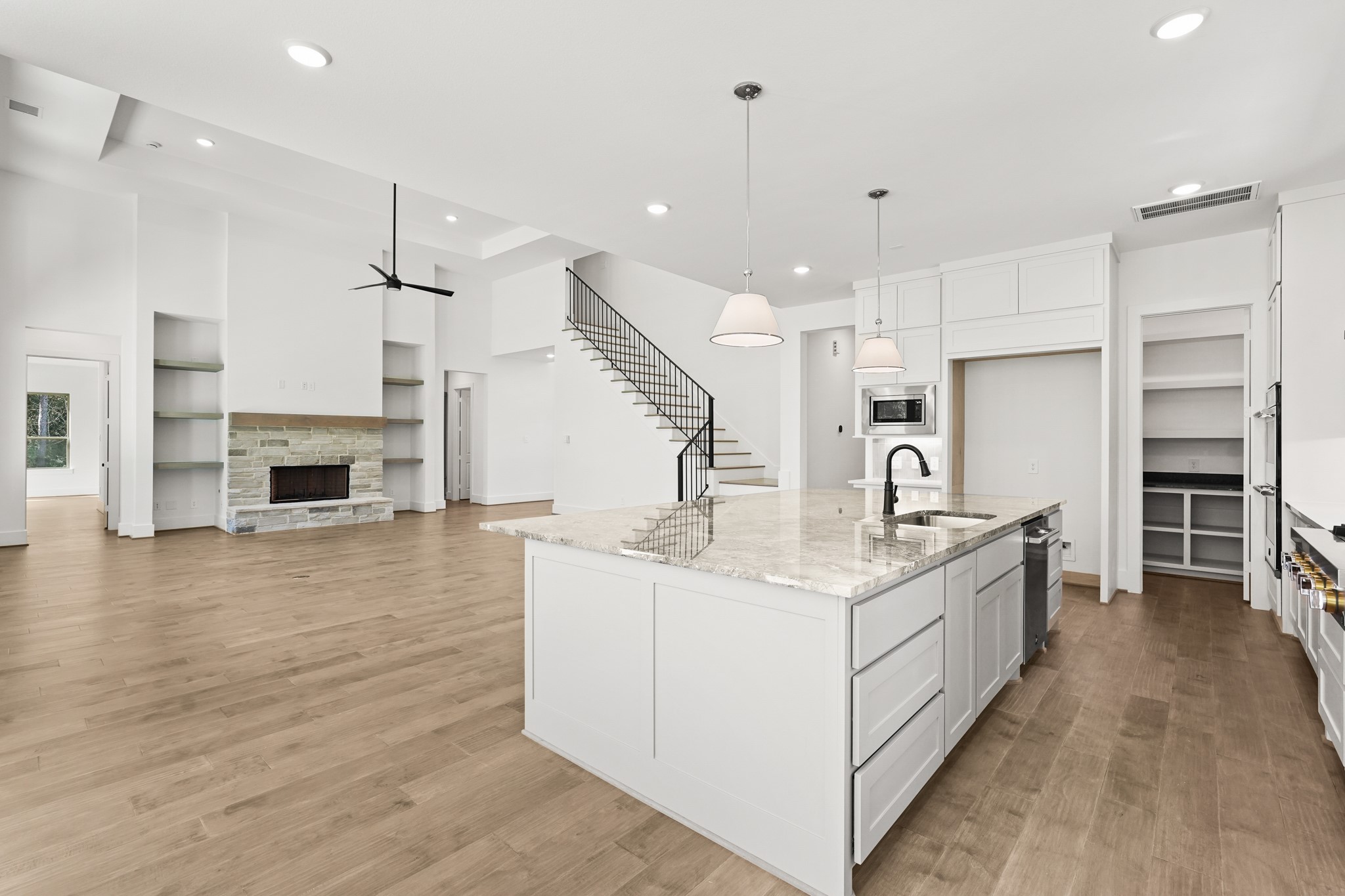 24919 Balmorhea Way Montgomery, TX 77316 - Photo 20 of 36 a large kitchen with stainless steel appliances kitchen island granite countertop a stove and a sink