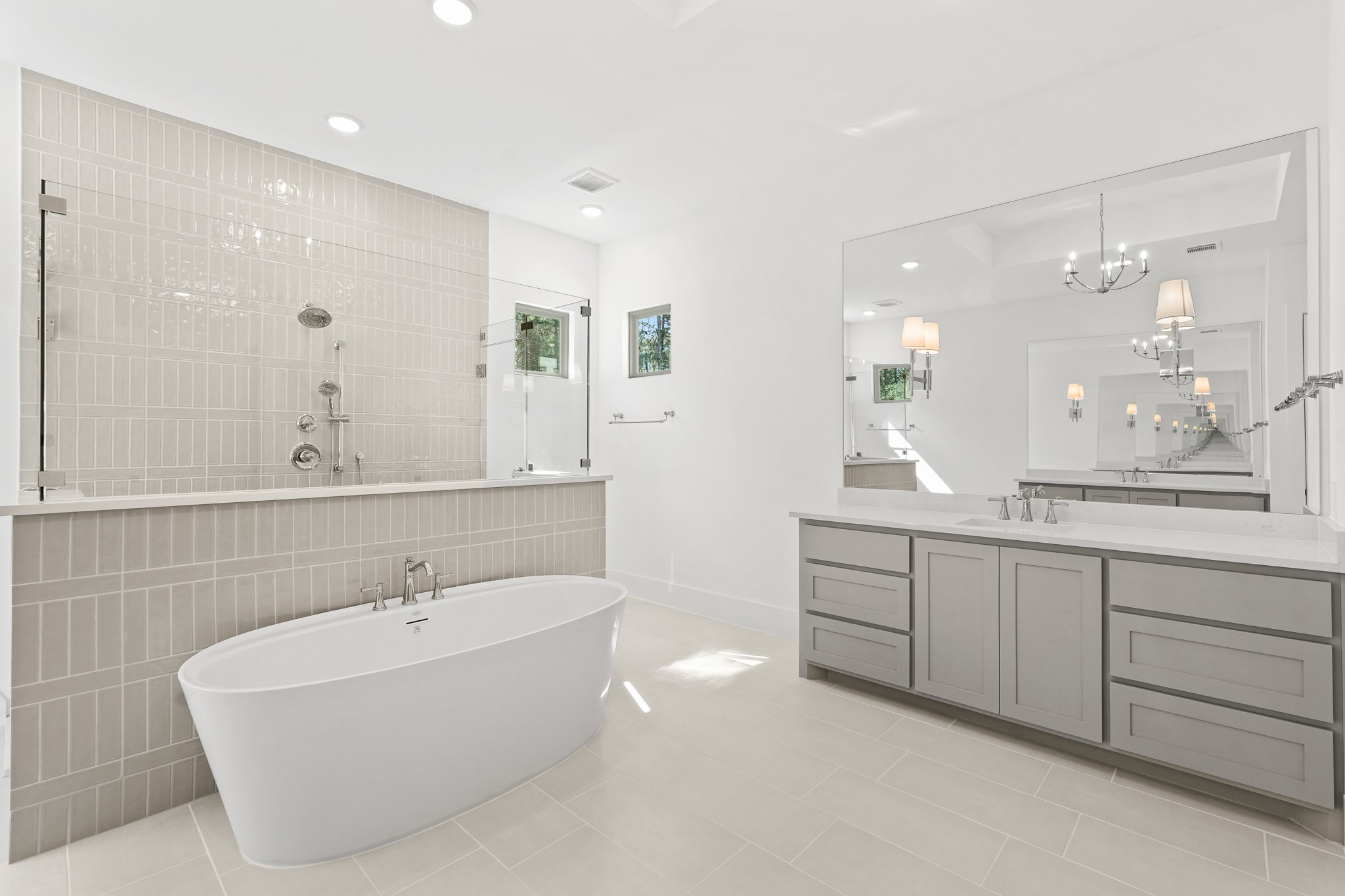 24919 Balmorhea Way Montgomery, TX 77316 - Photo 24 of 36 a bathroom with a tub sink double vanity and mirror