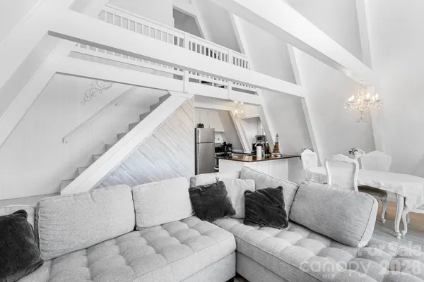 a living room with furniture and a ceiling fan