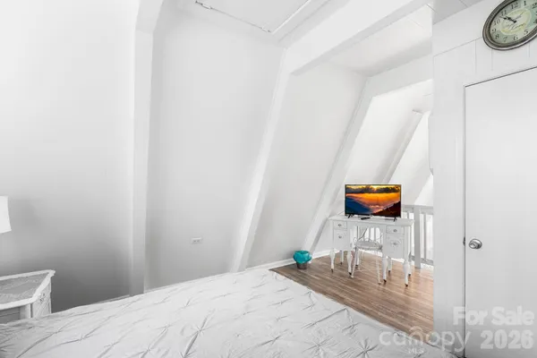 a bedroom with a bed and a tv on table