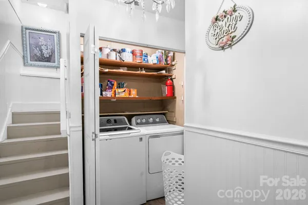 a view of a bedroom with wooden floor and workspace