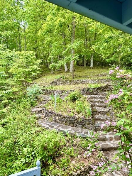 889 Big Ridge Road Franklin, NC 28734 - Photo 3 of 32 a backyard of a house with lots of green space and garden
