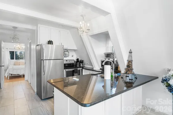 a kitchen with refrigerator and faucet