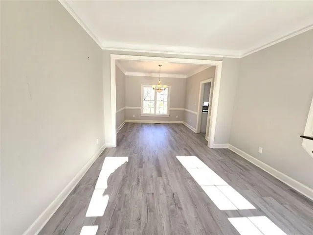 a view of a room with wooden floor and window