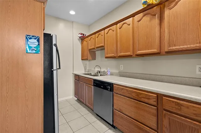 a kitchen with stainless steel appliances granite countertop a refrigerator and a sink