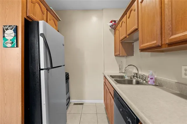 a kitchen with stainless steel appliances granite countertop a refrigerator and a sink