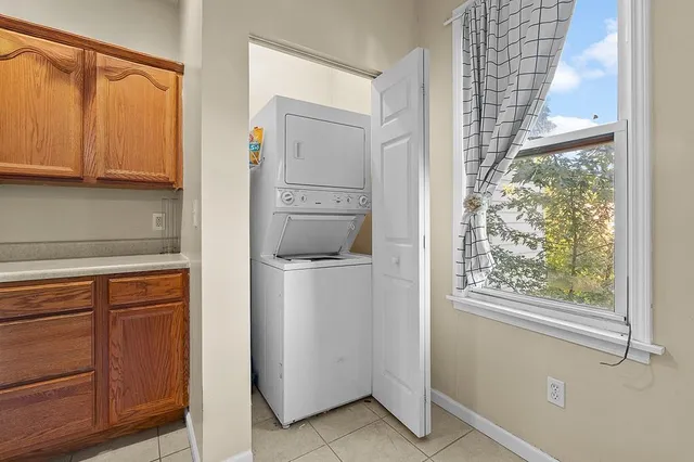a utility room with cabinets washer and dryer