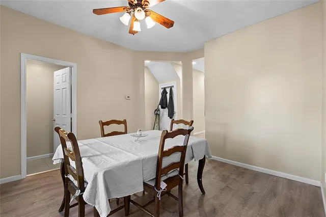 a view of a dining room with furniture and wooden floor