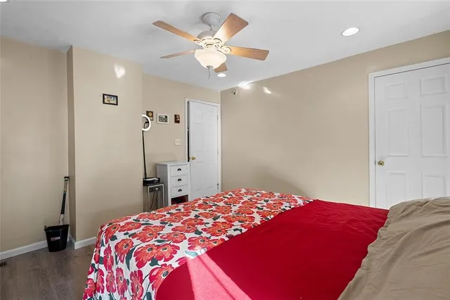 a bedroom with a large bed and a chandelier