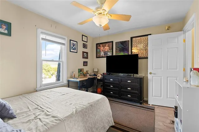 a bedroom with a bed and a flat screen tv