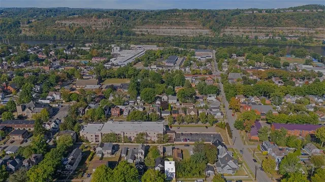 an aerial view of residential building with outdoor space and river