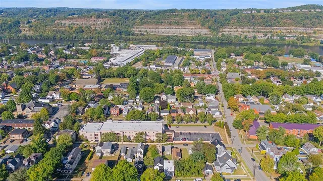 an aerial view of residential building with outdoor space and river