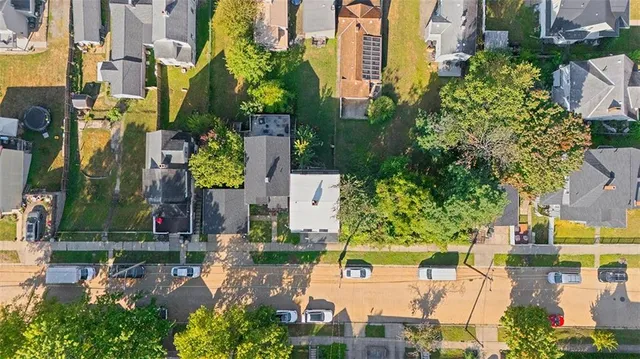 an aerial view of multiple houses with yard